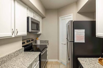Kitchen area with modern appliances and countertops
