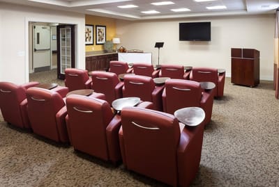 Bright common area with seating and a presentation space