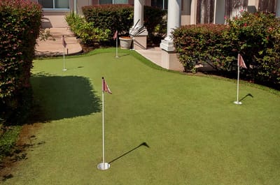 Artificial putting green with flags at a facility garden