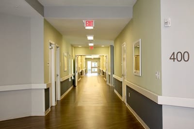 A hallway with doors leading to resident rooms