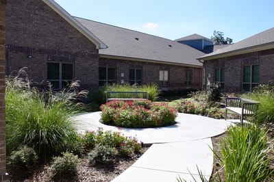 A beautifully landscaped garden area with benches