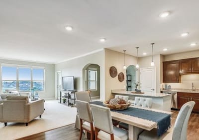 Bright and modern interior living area with kitchen and seating.
