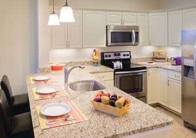 Bright kitchen area with fruit and table settings
