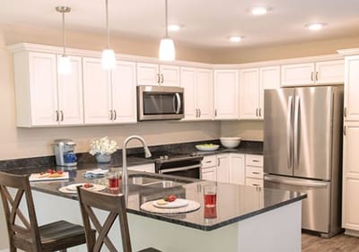 Modern kitchen with stainless steel appliances and counter seating
