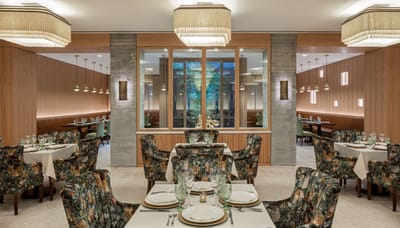 Bright dining area with floral upholstery and elegant decor