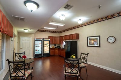 Bright common area with seating and kitchenette