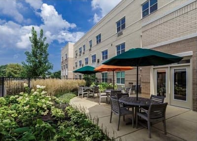 Outdoor seating area with umbrellas and garden