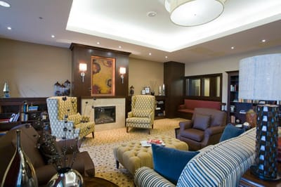 A cozy common area with seating and bookshelf
