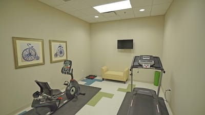 Fitness room with equipment and seating area
