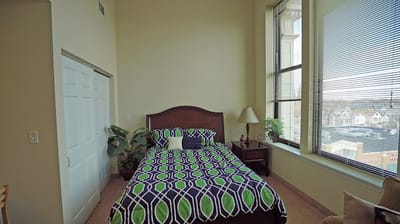 Cozy private room with a bed and window view