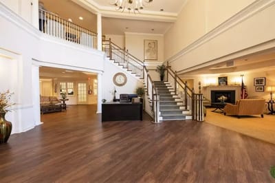 Bright common area with seating and a staircase