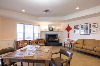 Bright common area with seating and a fireplace
