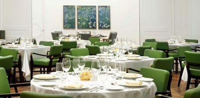 Elegant dining room set for a meal with art