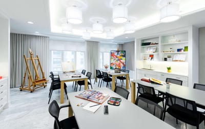 Bright activity room with art supplies and tables