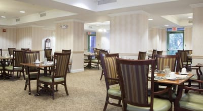 Dining area with tables and chairs set for meals