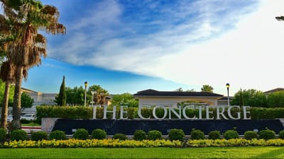 Signage for The Concierge facility with outdoor landscaping