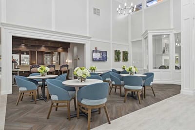 Bright dining room with tables and flowers