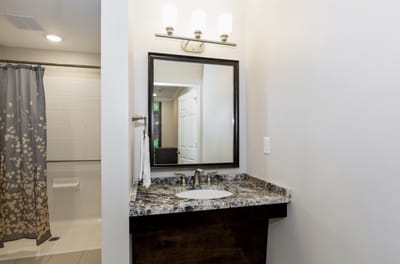 Modern bathroom with granite countertop and mirror