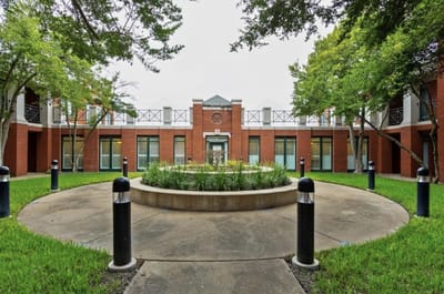 Outdoor courtyard with greenery and seating.