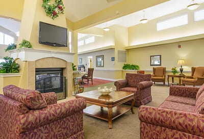 Bright common area with seating and a fireplace