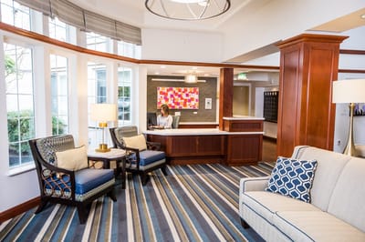 Bright lobby area with seating and staff at reception