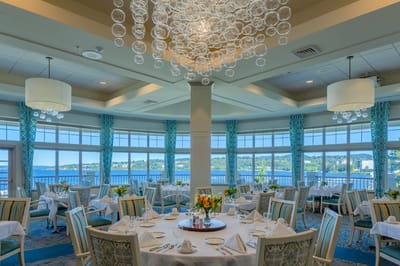 Elegant dining room with scenic views and flowers on tables