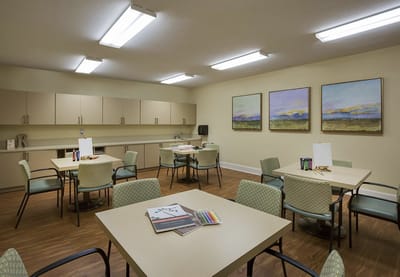 Bright activity room with art supplies and tables