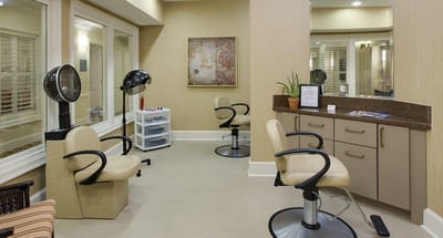 Beauty salon area with styling chairs and mirrors