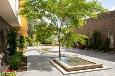 Outdoor patio area with fountains and greenery