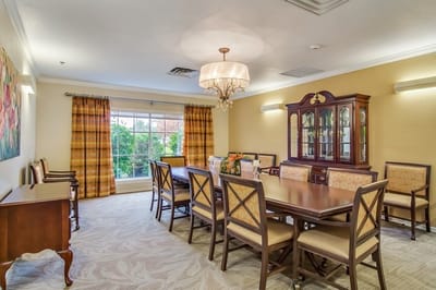 Bright dining room with a large table and chandelier