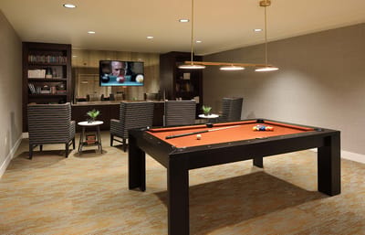 Interior billiards room with seating and TV