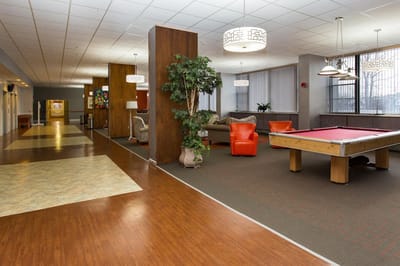 Bright common area with seating and a pool table