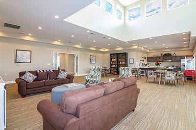 Bright common area with seating and kitchenette