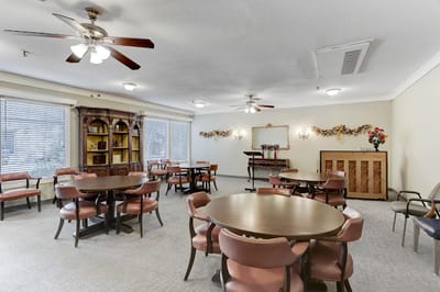 Common area with seating and piano in a senior living facility