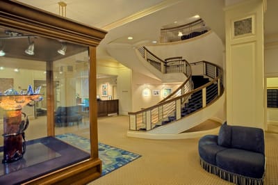 Interior view of a spacious lobby with stairs and art