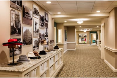 Interior hallway with hats displayed and wall photos