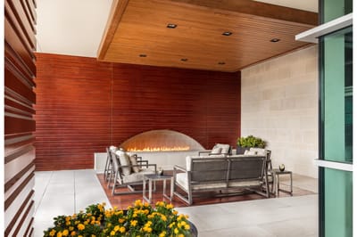 Outdoor seating area with a fireplace and flowers