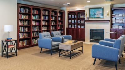 Cozy library area with comfortable seating and bookshelves