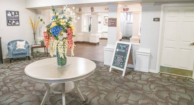 Bright common area with floral decoration and signage