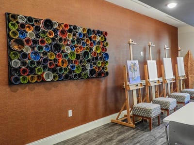 Interior view of an art room with easels and colorful wall decor