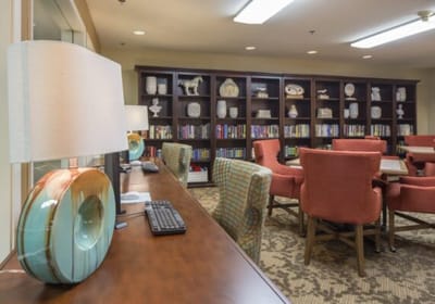 Bright interior of a common area with seating and bookshelves