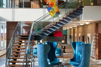 Modern common area with stylish seating and staircase