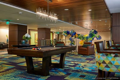 Interior common area with pool table and colorful decor
