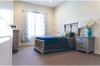 Cozy private room with a bed and bedside table
