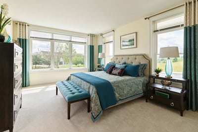 Comfortable and well-lit bedroom in a senior living facility