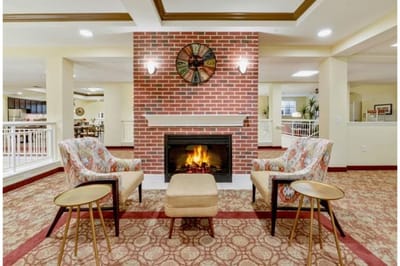 Interior common area with a fireplace and seating