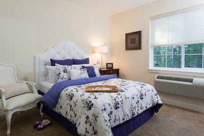 Cozy private bedroom with floral bedding and natural light