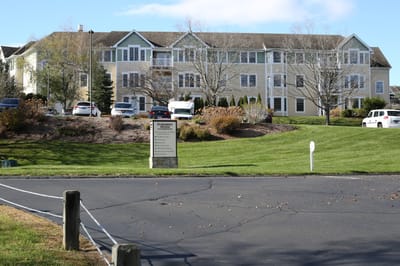 Exterior view of Evergreen Woods facility with landscaped area