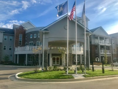 Exterior view of the facility entrance with flags
