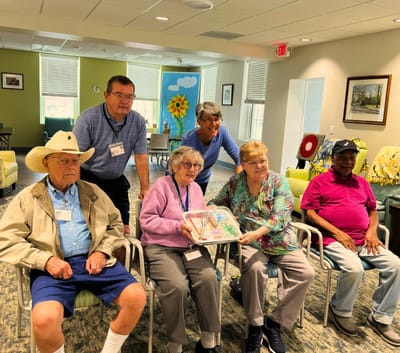 Residents and staff participating in an activity indoors